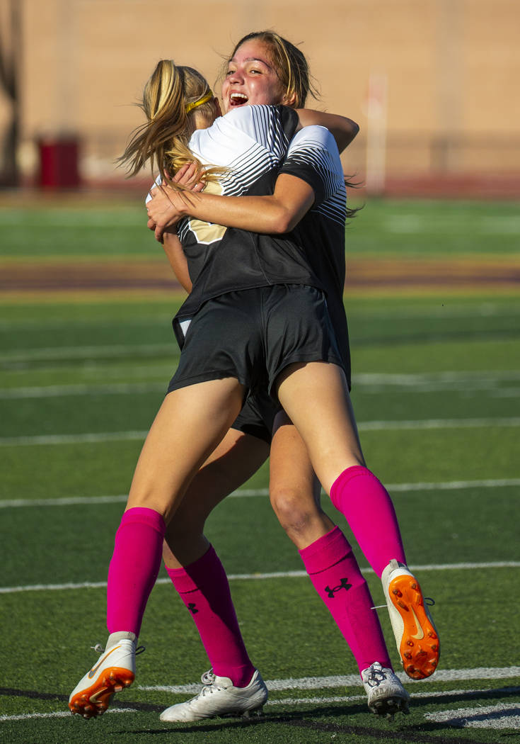 Faith Lutheran's Serene Gronauer (15, facing) hugs teammate Mackenzie Folk (8) after scoring on ...