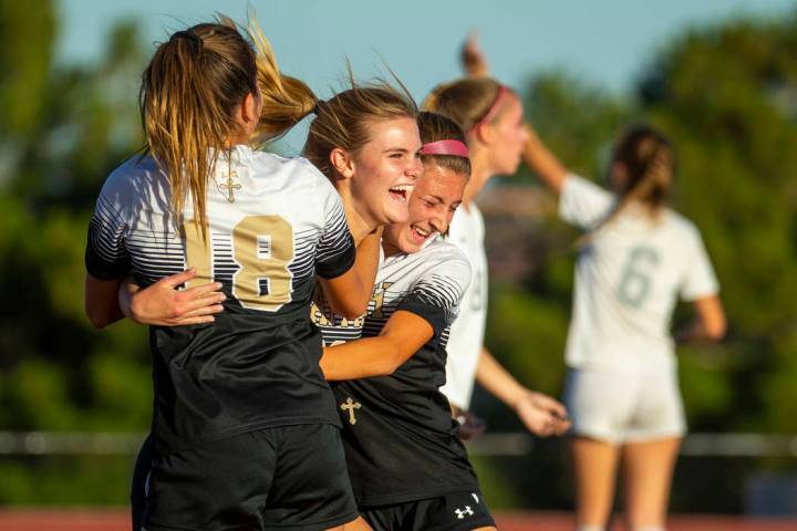 Faith Lutheran's Amelia McManus (20, center) celebrates a goal with teammates Addy Radwanski (1 ...