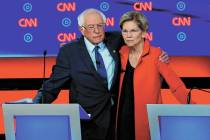 Sen. Bernie Sanders, I-Vt., and Sen. Elizabeth Warren, D-Mass., embrace after the first of two ...