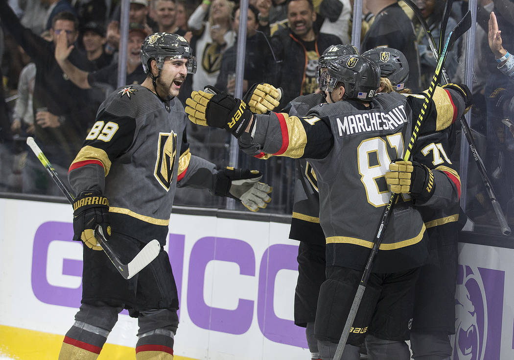 Vegas Golden Knights right wing Alex Tuch (89) celebrates with Vegas Golden Knights center Jona ...