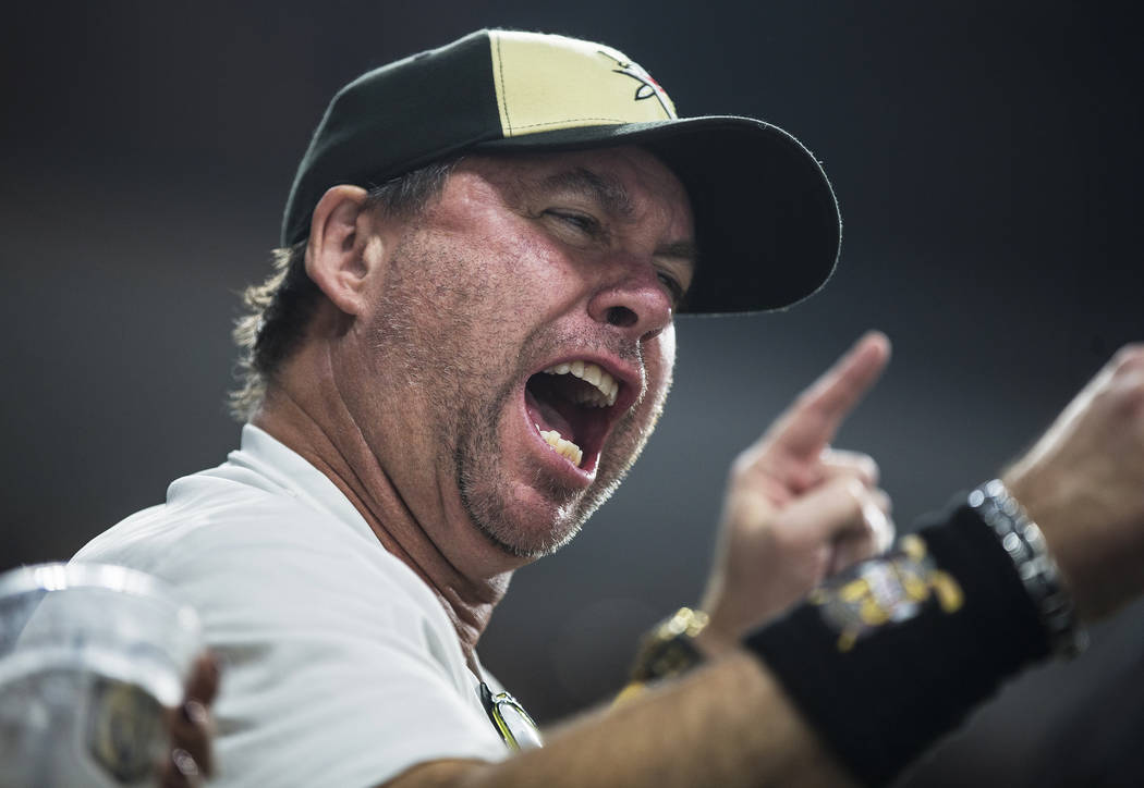 Fans cheer for the Golden Knights in the first period during their NHL hockey game with the Chi ...