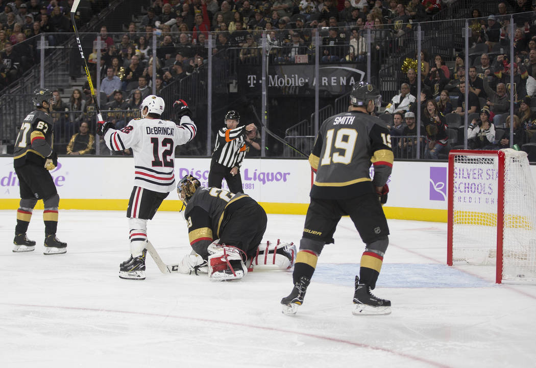 Chicago Blackhawks right wing Alex DeBrincat (12) celebrates after Chicago Blackhawks defensema ...