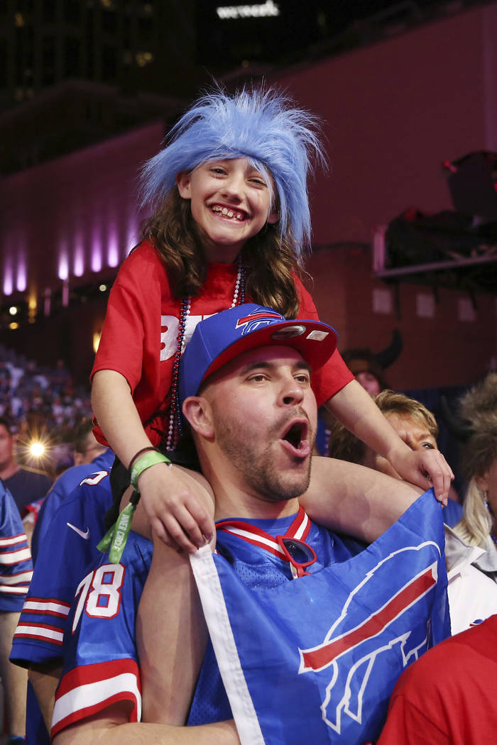 Fans cheer on the main stage during the second round of the NFL football draft, Friday, April 2 ...