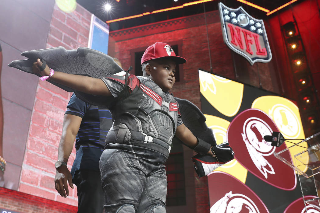 A young Atlanta Falcons fan poses on the main stage during the sixth round of the NFL football ...