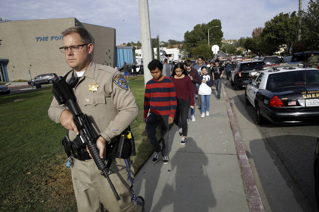 Students are escorted out of Saugus High School after reports of a shooting on Thursday, Nov. 1 ...