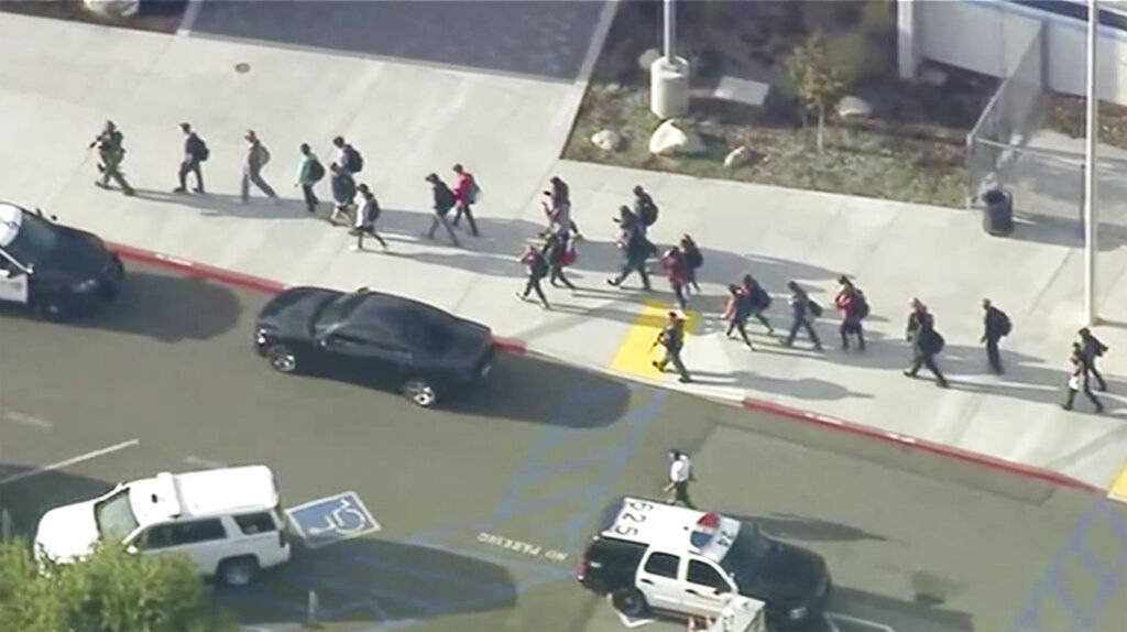People are led out of Saugus High School after reports of a shooting on Thursday, Nov. 14, 2019 ...