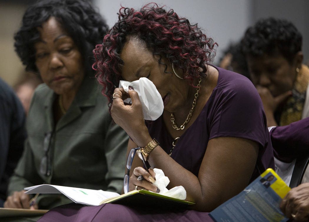 Sonja Mason, center, Tyrone Thompson's sister, is comforted by her aunt Bea Soares, left, at th ...