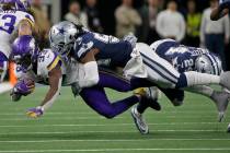 Minnesota Vikings running back Dalvin Cook (33) is tackled by Dallas Cowboys middle linebacker ...