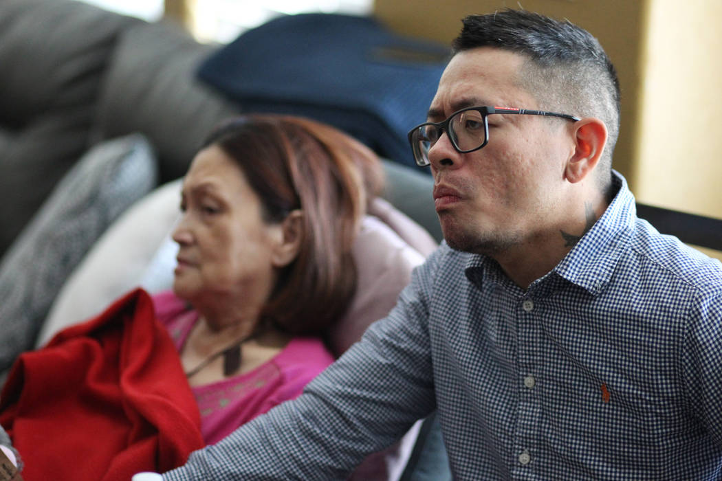Nimfa Escobia, 67, left, with her son Nimar, are interviewed about a car accident that killed t ...