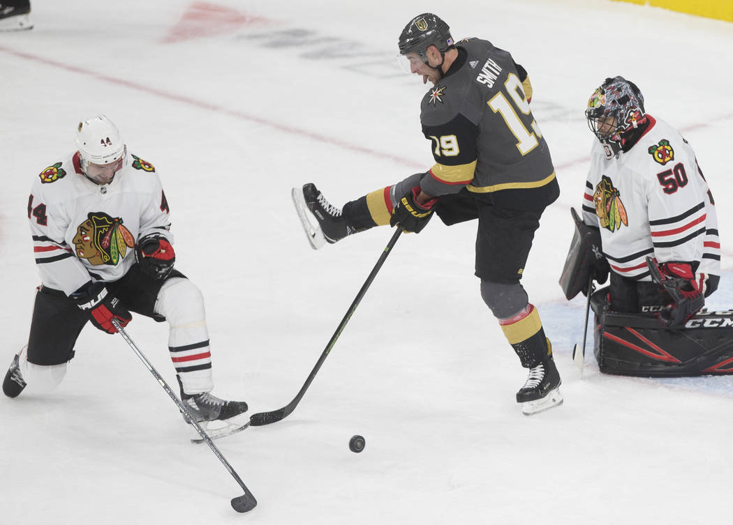 Vegas Golden Knights right wing Reilly Smith (19) tries to deflect a puck past Chicago Blackhaw ...