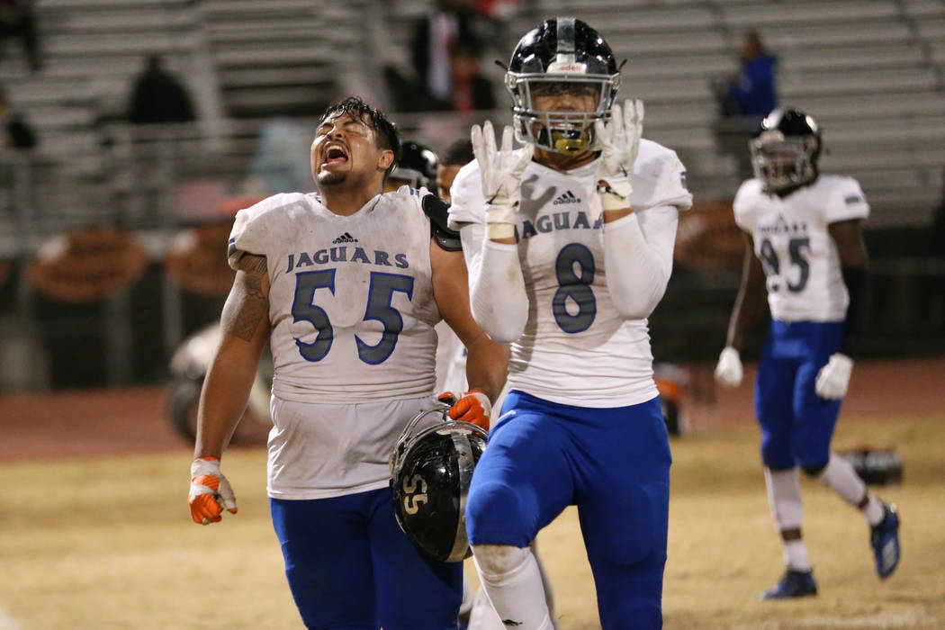 Desert Pines players Blaze Homalon (55), and Will Paden (8), celebrate after a 42-21 win agains ...