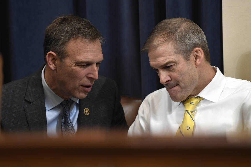 Rep. Scott Perry, R-Pa., talks with Rep. Jim Jordan, R-Ohio, during a break in testimony from f ...