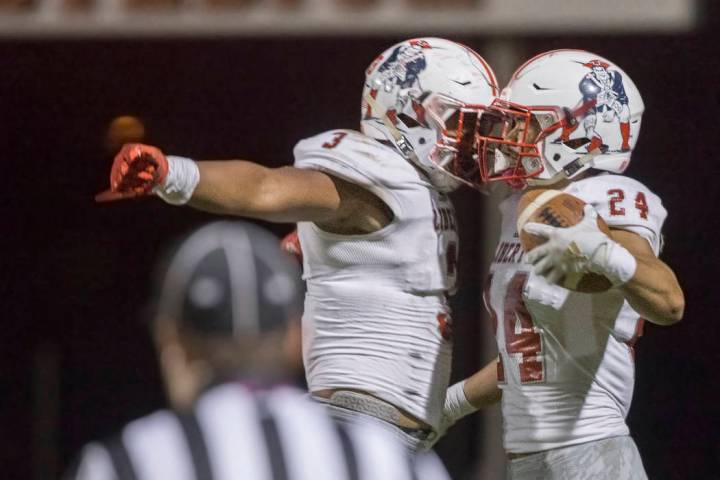 Liberty junior linebacker Zephania Maea (3) and senior safety Lehi Ausage (24) celebrate after ...