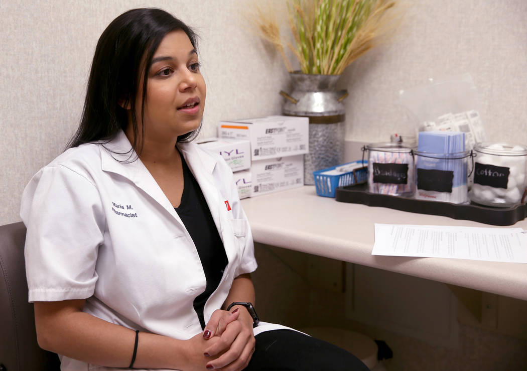 Pharmacy Manager Maria Masood talks to a reporter about high flu activity in Las Vegas and Neva ...