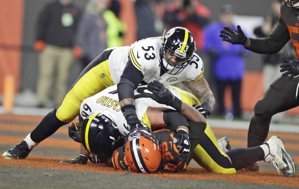 Cleveland Browns defensive end Myles Garrett (95) is punched by Pittsburgh Steelers center Maur ...