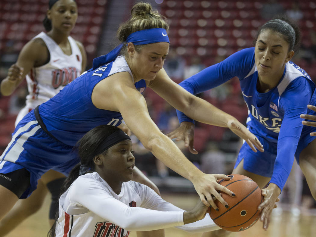 UNLV Lady Rebels forward Anna Blount (12) fights for a loose ball with Duke Blue Devils guard H ...
