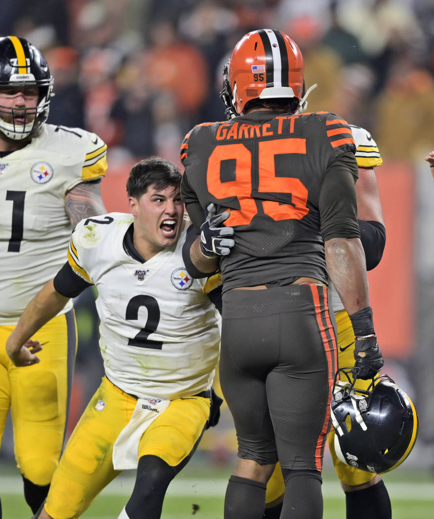 Pittsburgh Steelers quarterback Mason Rudolph (2) goes after Cleveland Browns defensive end Myl ...