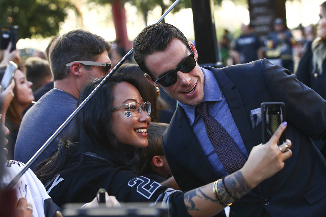 Golden Knights' Reilly Smith poses for pictures on the gold carpet after arriving for the NHL s ...