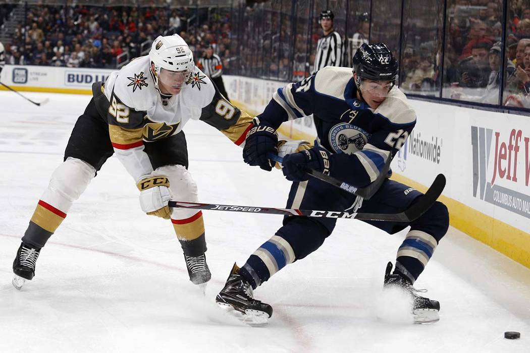 Columbus Blue Jackets forward Sonny Milano, right, chases the puck in front of Vegas Golden Kni ...