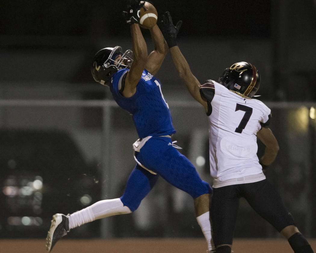 Desert Pines freshman wide receiver Deandre Moore (2) makes a leaping touchdown catch over Fait ...