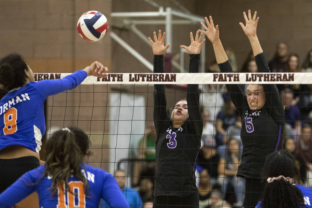 Bishop Gorman's Taylor Jefferson (8) spikes the ball against Durango's Sophia Dominguez (3) and ...