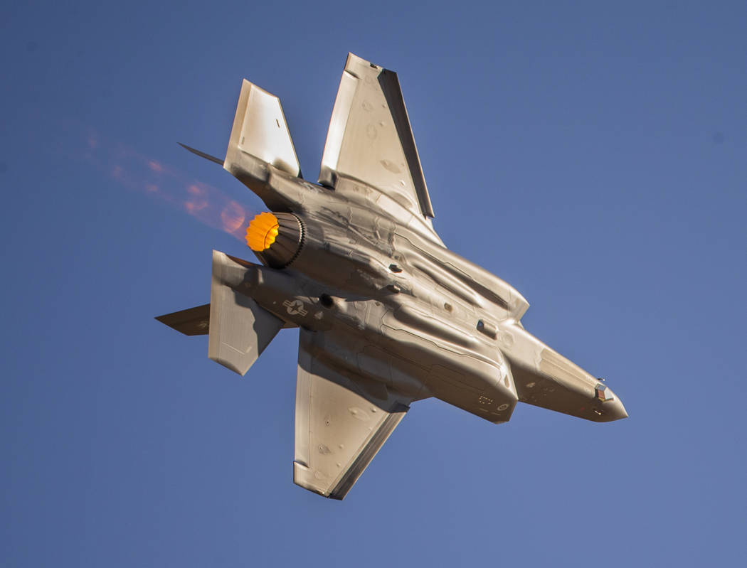 An F-35 Lightning II powers across the flight line before the crowd during the Aviation Nation ...