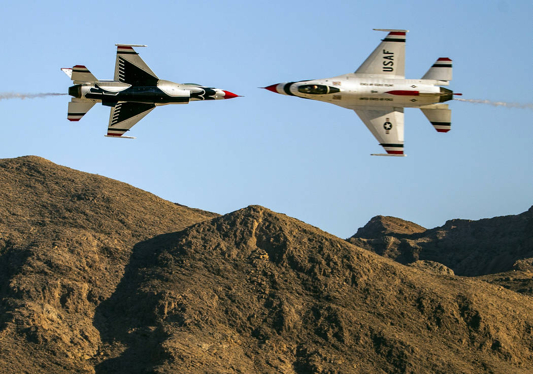 Two U.S. Air Force Thunderbirds pass within a short distance of each other during the Aviation ...