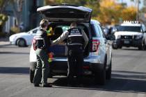 Las Vegas police investigate the scene of a shooting that left a boy dead at the intersection o ...