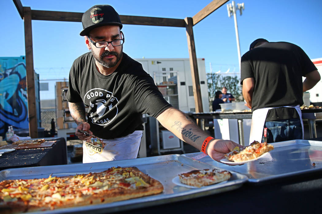 Gilbert Perez of Good Pie serves a slice of pizza during the Las Vegas Pizza Festival at The In ...