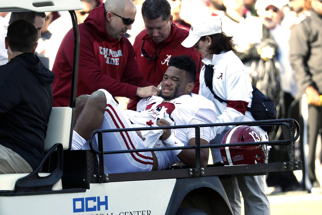 Alabama quarterback Tua Tagovailoa (13) is carted off the field after getting injured in the fi ...