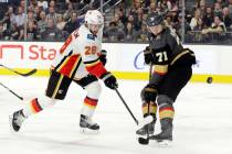 Vegas Golden Knights center William Karlsson (71) defends as Calgary Flames center Elias Lindho ...