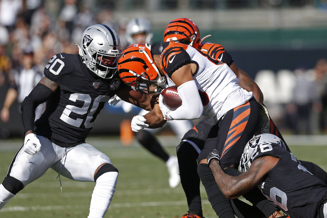 Cincinnati Bengals wide receiver Tyler Boyd is stopped with the ball by Oakland Raiders cornerb ...