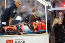 Cincinnati Bengals wide receiver Auden Tate flashes a thumbs up while being carried off the fie ...