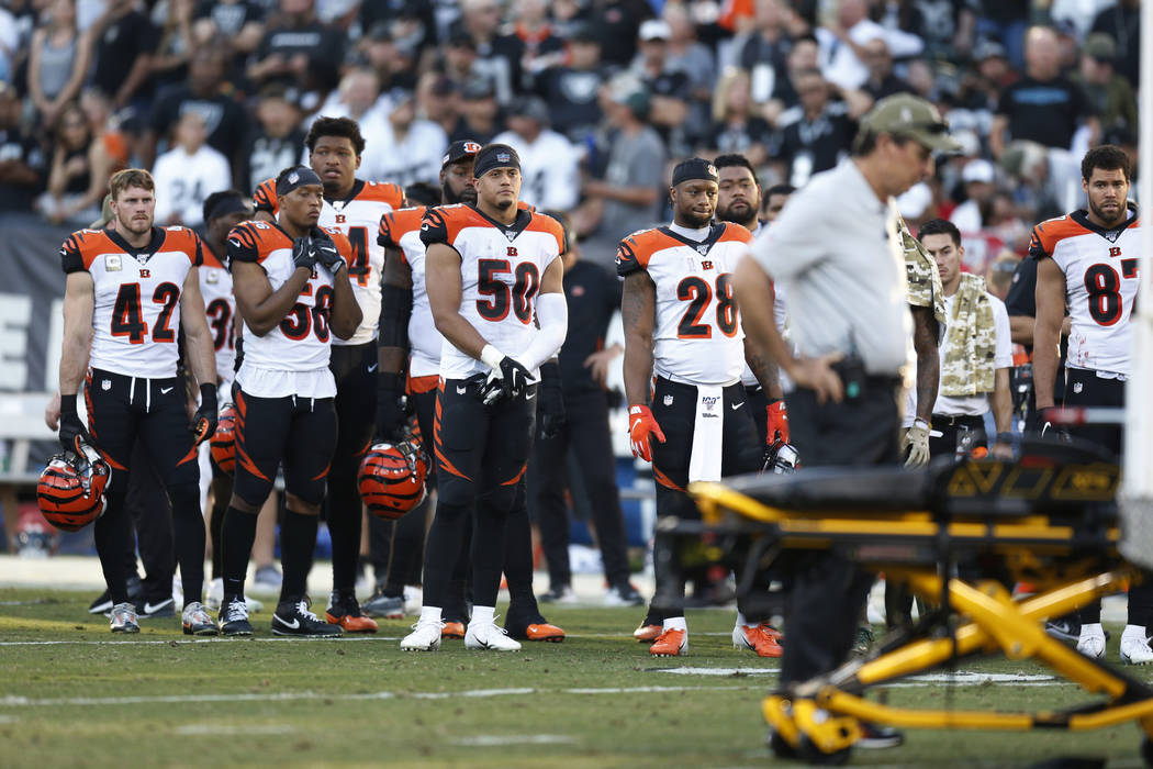 The Cincinnati Bengals look on as Bengals wide receiver Auden Tate is carried off the field aft ...