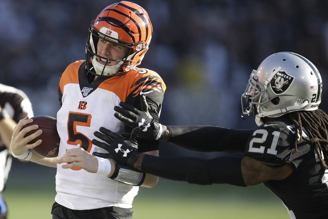 Cincinnati Bengals quarterback Ryan Finley is knocked out of bounds by Oakland Raiders free saf ...