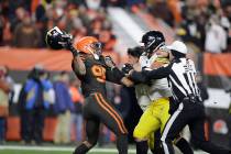 Cleveland Browns defensive end Myles Garrett, left, gets ready to hit Pittsburgh Steelers quart ...