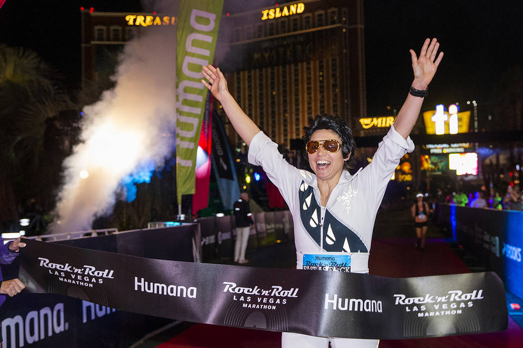 Women's marathon winner Heather Bray crosses the finish line during the Las Vegas Rock 'n' Roll ...