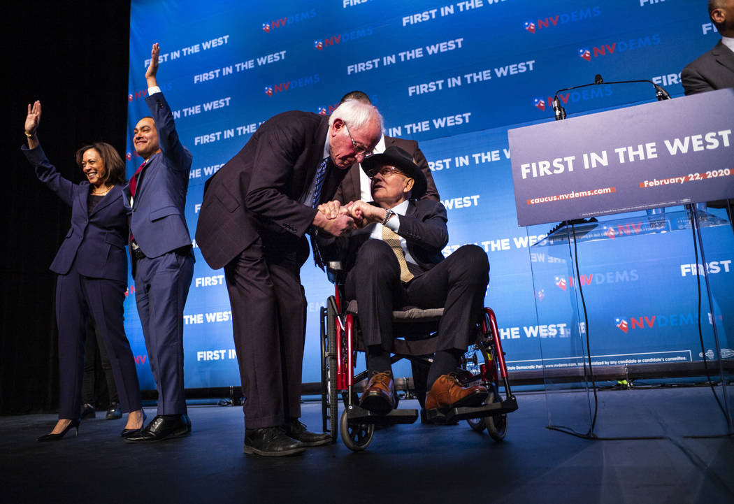 Democratic presidential candidate Sen. Bernie Sanders, I-Vt., center left, greets U.S. Sen. Har ...