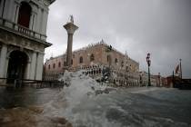 Water starts coming in as the city awakes, in Venice, Italy, Sunday, Nov. 17, 2019. Venetians a ...