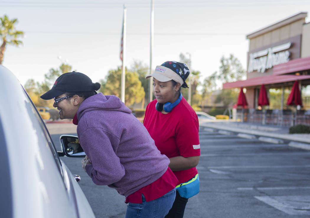 Krispy Kreme processors Sandra Nunez, left, and Kiley Burrell tell a Golden Knight fan that the ...