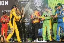 Kyle Busch, front left, celebrates with teammates in Victory Lane after winning a NASCAR Cup Se ...