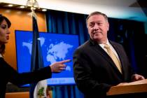 Secretary of State Mike Pompeo, right, pauses as State Department spokeswoman Morgan Ortagus, l ...