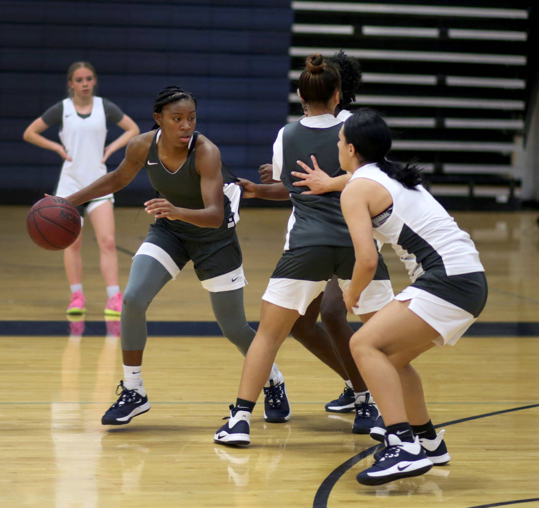 Centennial senior TeiOnni McDaniel, dribbles the ball in a drill during varsity girls practice ...