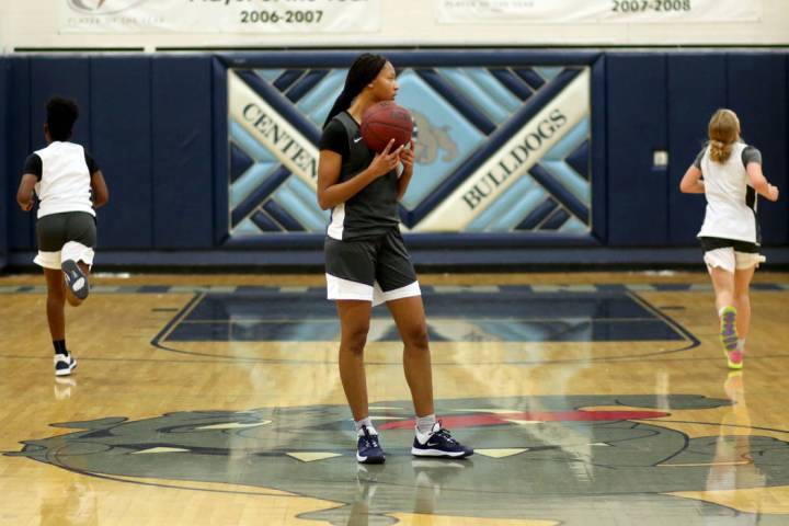 Centennial junior Taylor Bigby, center, holds the ball after beating her teammates in a drill ...