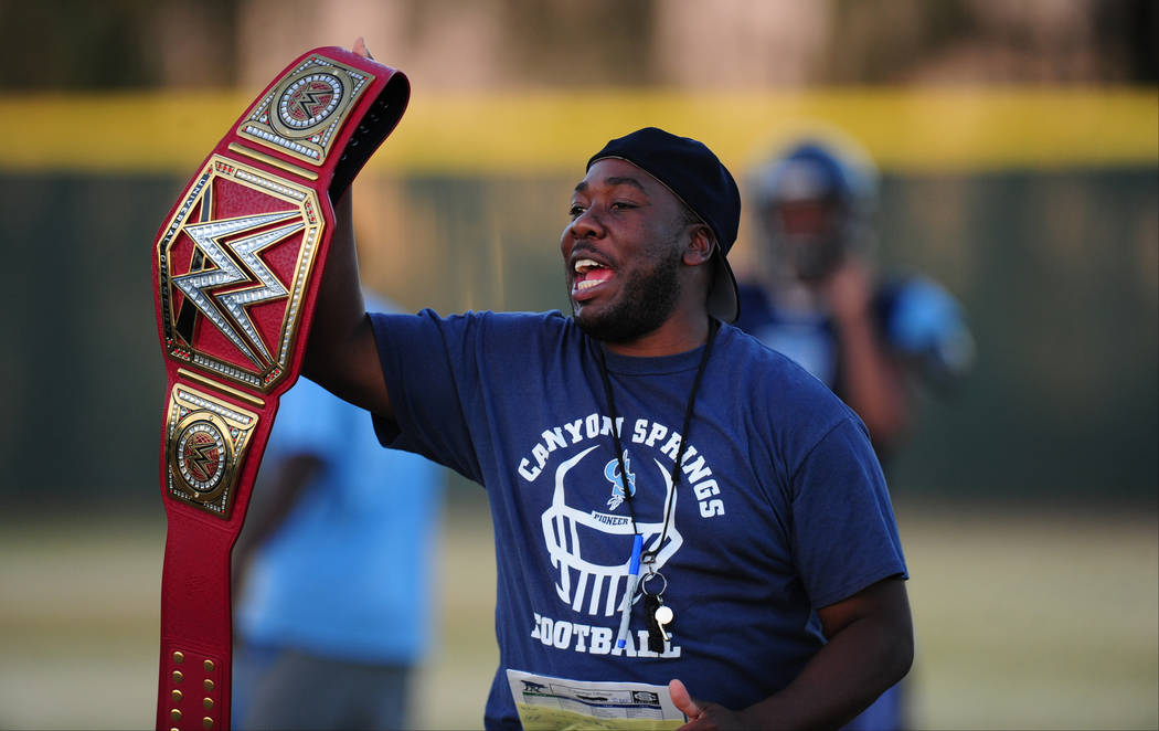 Canyon Springs head coach Gus McNair holds a WWE title belt during practice at Canyon Springs H ...