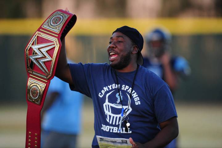 Canyon Springs head coach Gus McNair holds a WWE title belt during practice at Canyon Springs H ...