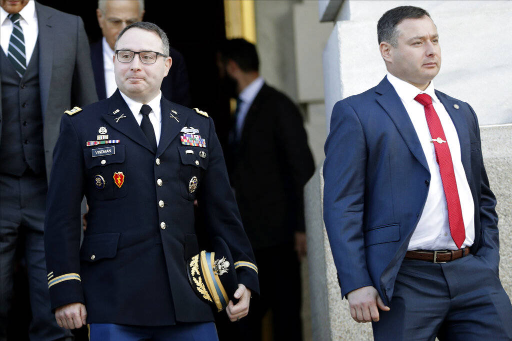 National Security Council aide Lt. Col. Alexander Vindman, left, walks with his twin brother, A ...