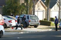 Fresno police investigators work the driveway where a shooting took place at a house party whic ...