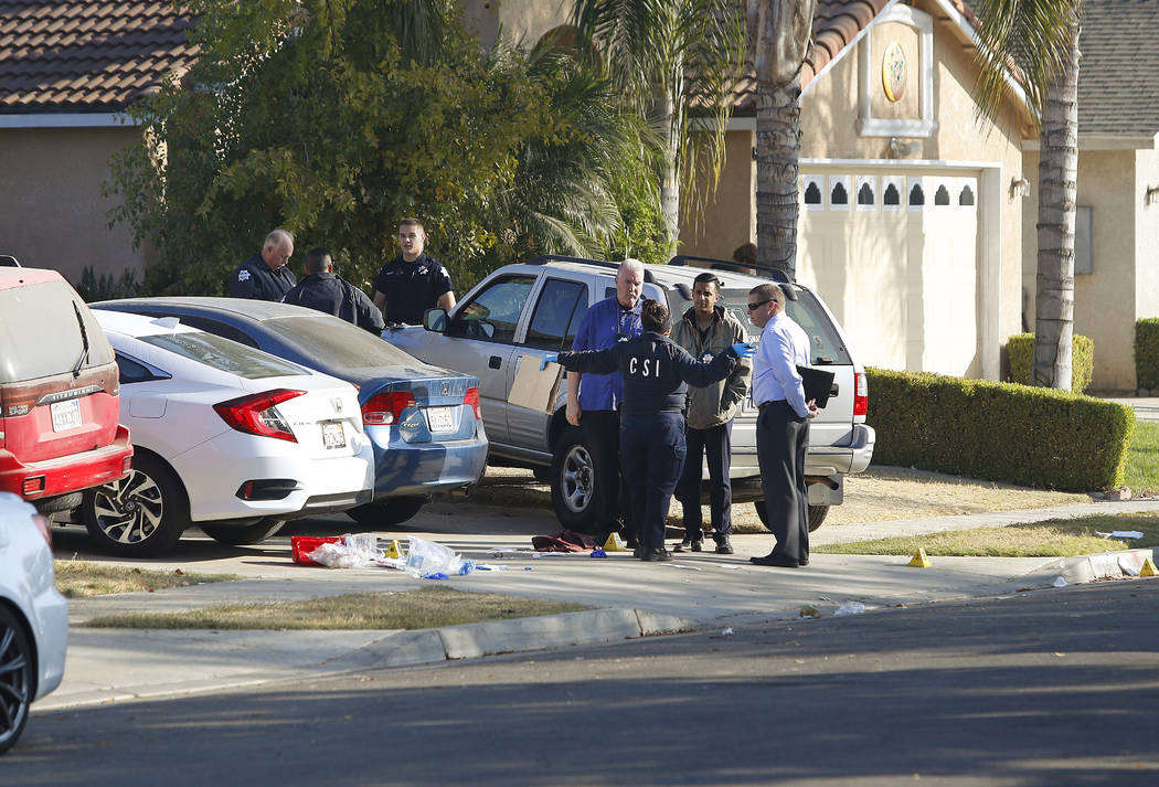 Fresno police investigators work on the scene where a shooting took place at a house party whic ...