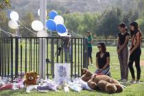 Parent Mirna Herrera kneels with her daughters Liliana, 15, and Alexandra, 16 at the Central Pa ...